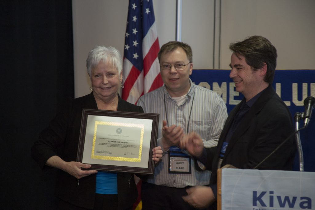 Sandra Woodrow (right) receives the 2016 Community Service Recognition award from Larry Clark and Pullman Kiwanis president Kerry Swanson.